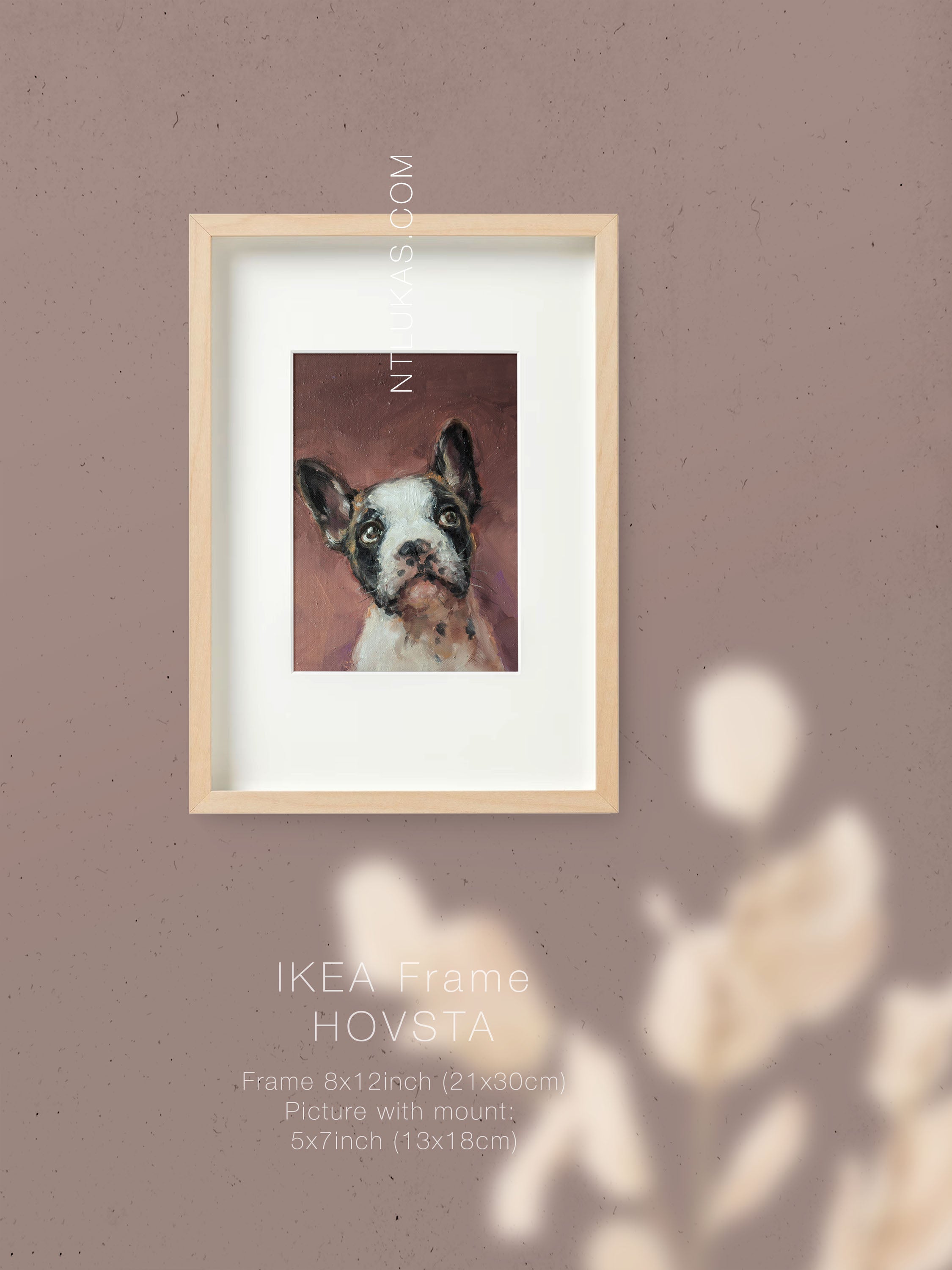 Framed picture of a dog with 'IKEA Frame HOVSTA' on a brown wall.